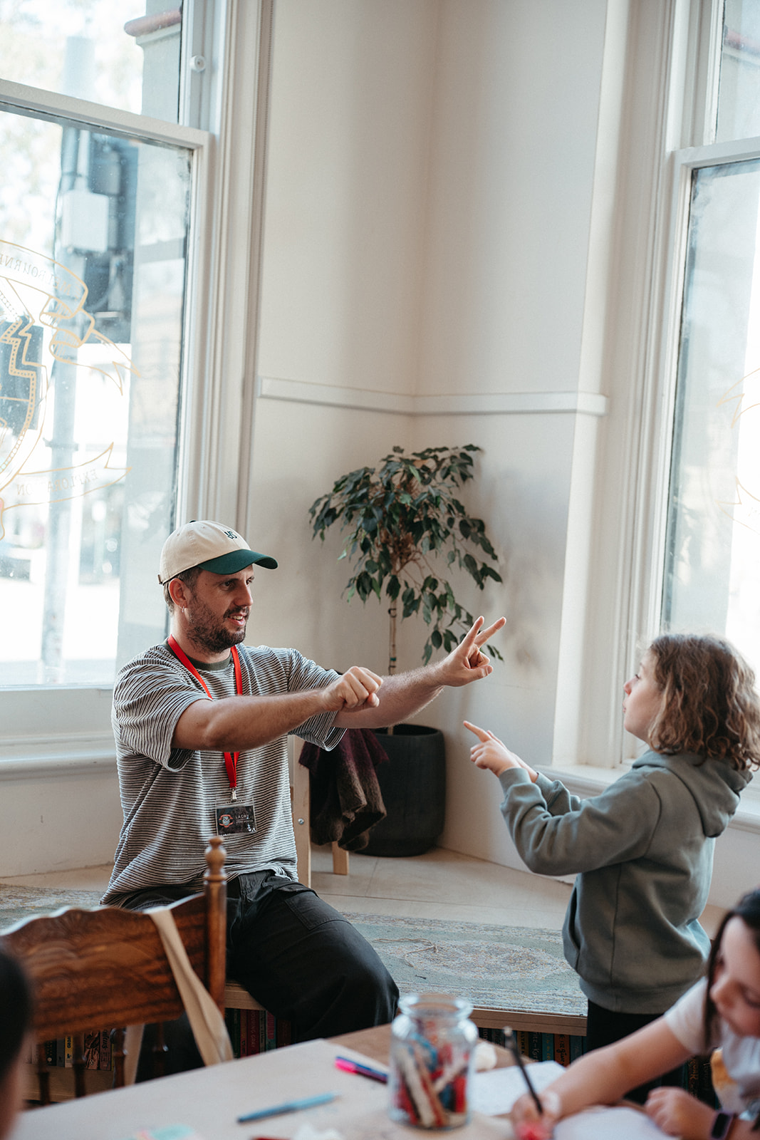 Story mentor and young writer exploring an idea through play